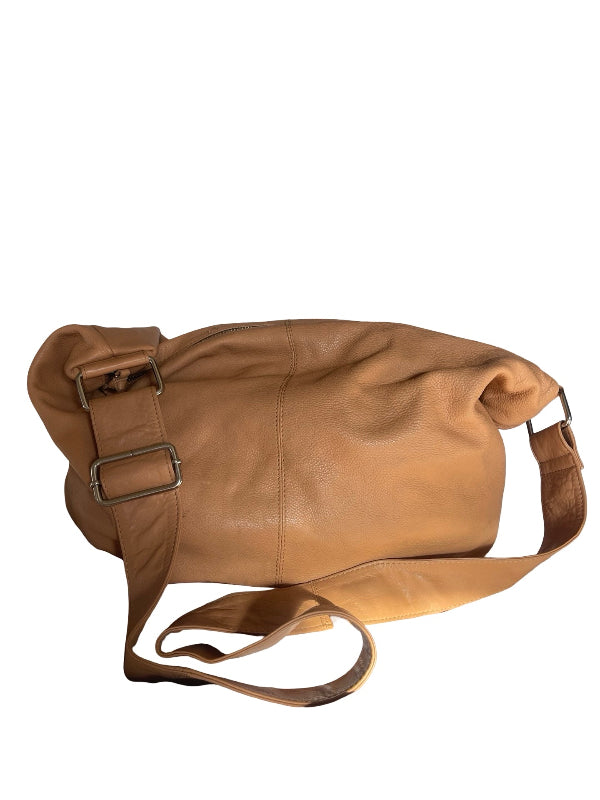 A tan leather shoulder bag with a wide adjustable strap and metal buckle details, shown against a plain white background.