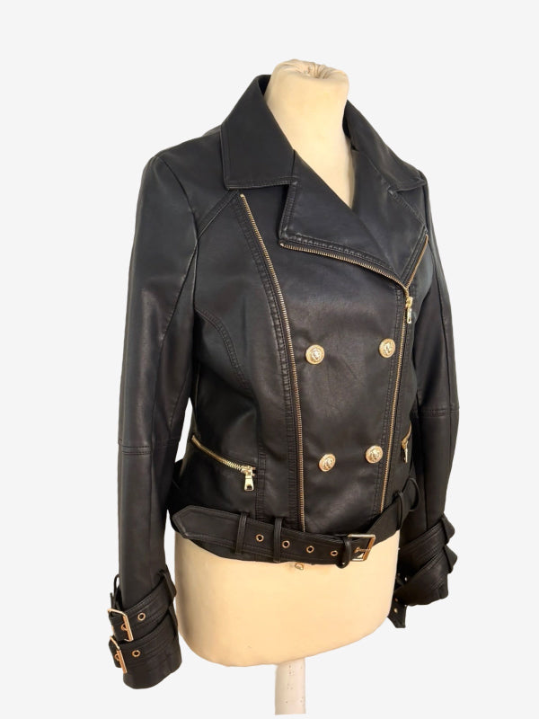 Black faux leather motorcycle jacket with gold-tone hardware, displayed on a beige mannequin torso against a light gray background.