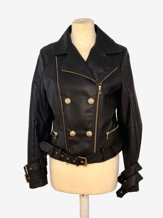 A black faux leather motorcycle jacket with gold-tone hardware, displayed on a cream-colored mannequin torso against a light gray background.