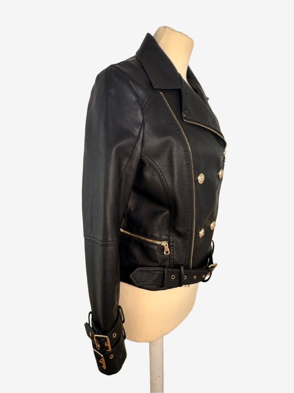 Black faux leather motorcycle jacket with gold-tone hardware, displayed on a beige mannequin torso against a light gray background.