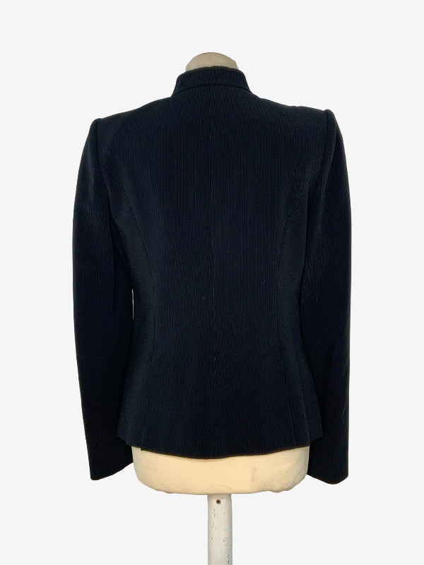 A  black pinstripe tailored jacket displayed on a cream-colored mannequin torso, showing the back view against a plain white background