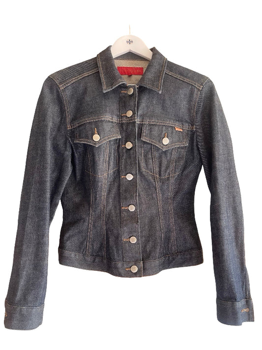 A dark blue washed Italian denim jacket with silver-tone buttons, displayed on a white hanger against a plain white background.