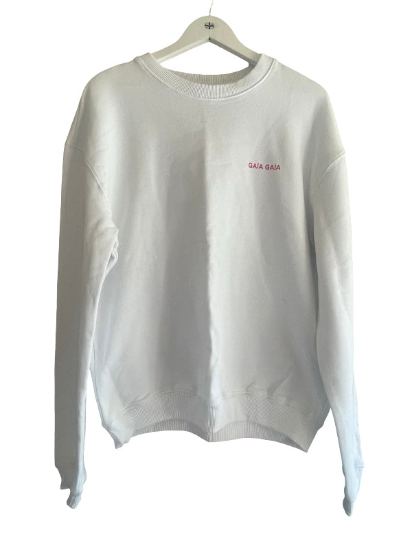 A white crewneck sweatshirt with 'GALA GALA' embroidered in pink on the left chest, hanging on a white wooden hanger against a white background.