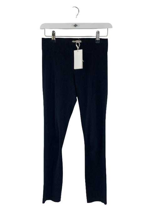A pair of black ankle leggings hanging from a white plastic hanger with metal clips against a plain white background.