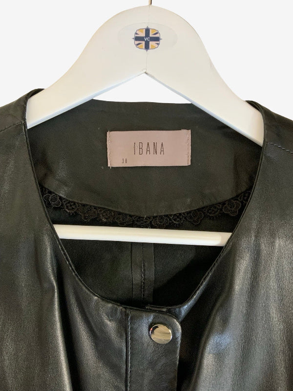 A close-up of a black luxury leather jacket or top hanging on a white hanger. The inner collar label reads IBANA, and a small lace trim is visible along the neckline.