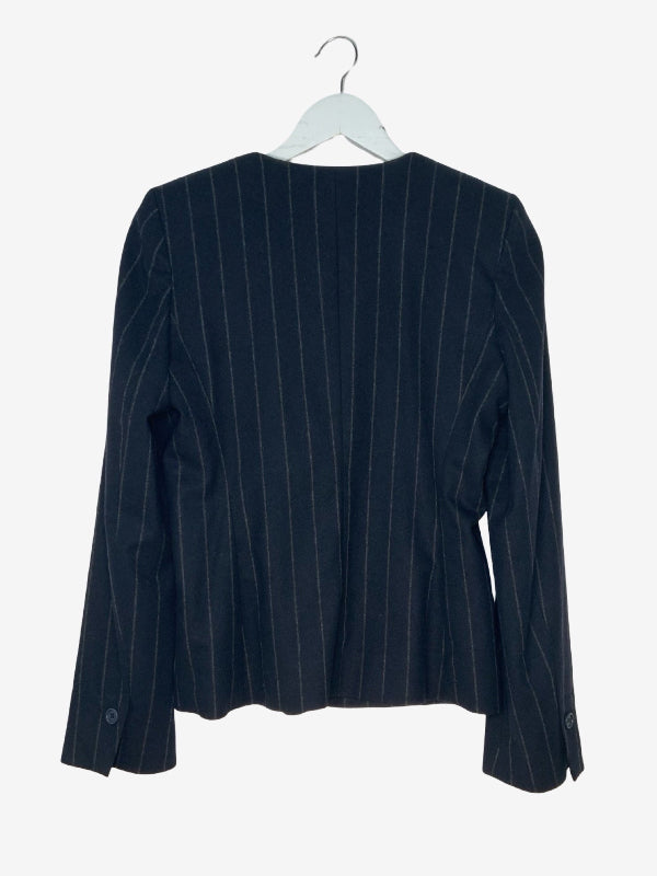 A dark navy blue pinstripe blazer jacket hanging on a white hanger against a light gray background.