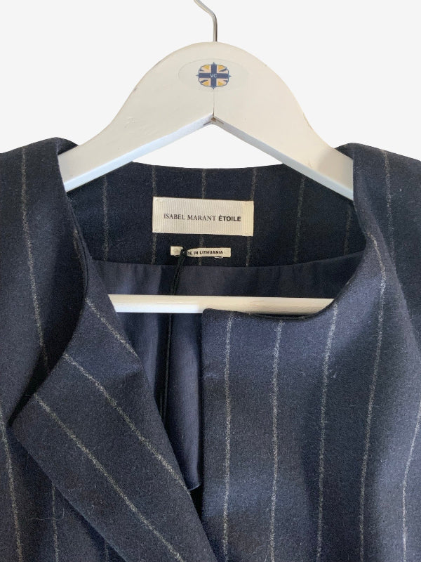 A close-up of a dark navy blue pinstripe blazer hanging on a white hanger. The brand label 'Isabel Marant Etôile' is visible inside the collar.