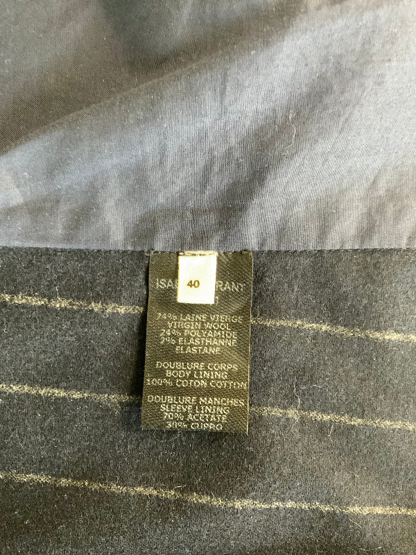 A close-up of a garment's interior label reading 'ISABEL MARANT' and '40', attached to blue striped fabric with a satin-like upper section.