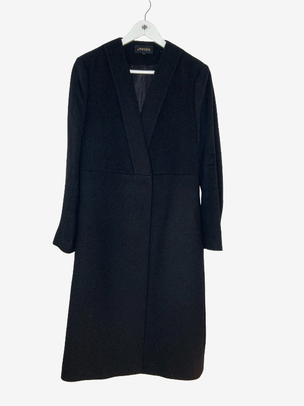 A black long-line wrap coat with a shawl collar, hanging on a white hanger against a plain light gray background.