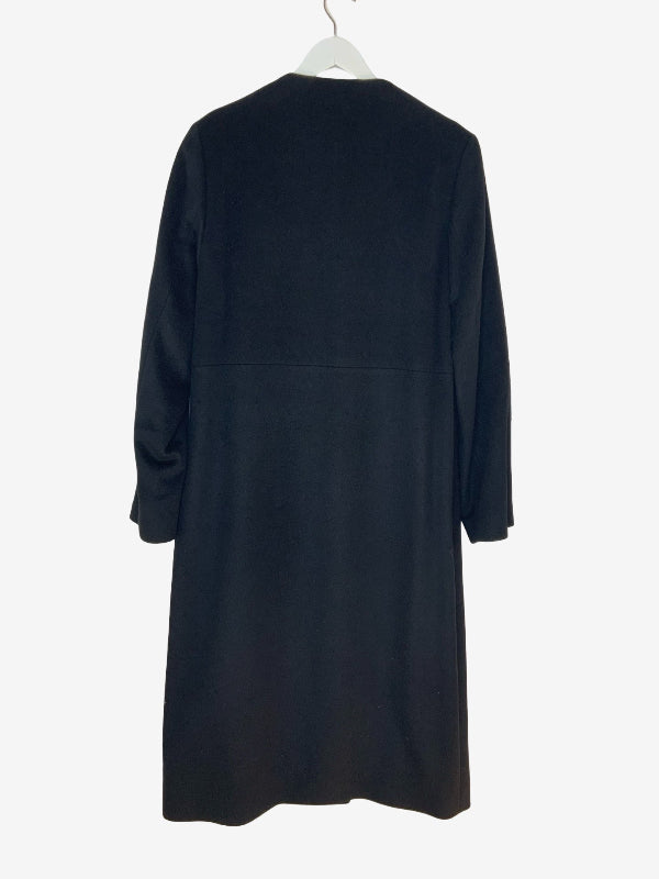A black long-sleeve dress or tunic hanging on a white hanger against a plain white background, showing the back view.