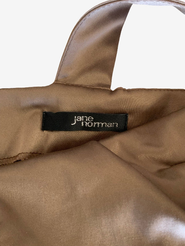 Close-up of a brown satin handbag with a black fabric brand label reading 'jane norman'.