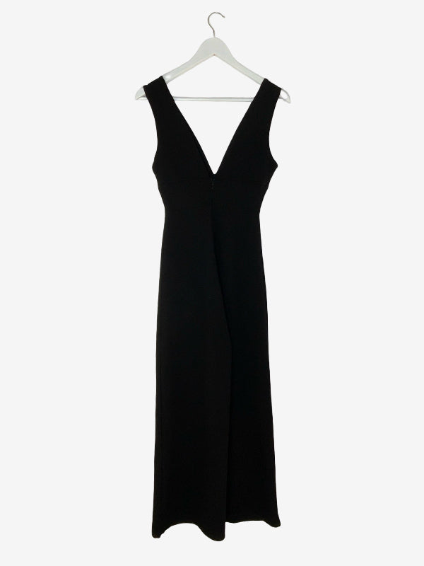 A black sleeveless maxi jumpsuit with a deep V-neckline, hanging on a white hanger against a plain white background.