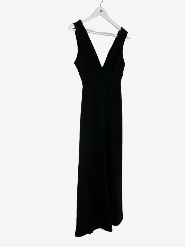 A sleeveless black jumpsuit with a deep V-neckline, hanging on a white plastic hanger against a plain white background.
