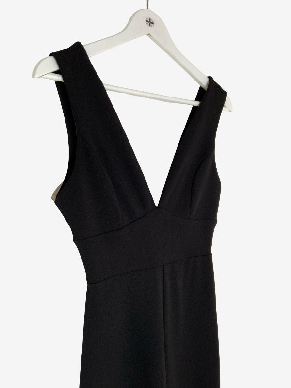 A black sleeveless V-neck jumpsuit hanging on a white hanger against a plain white background.