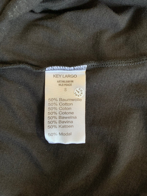 Close-up of a clothing size and material tag reading KEY LARGO, with fabric composition listed as 50% Baumwolle, 50% Cotton, 50% Coton, 50% Cotone, 50% Baweelna, 50% Bavina, and 50% Katoen, on black fabric.