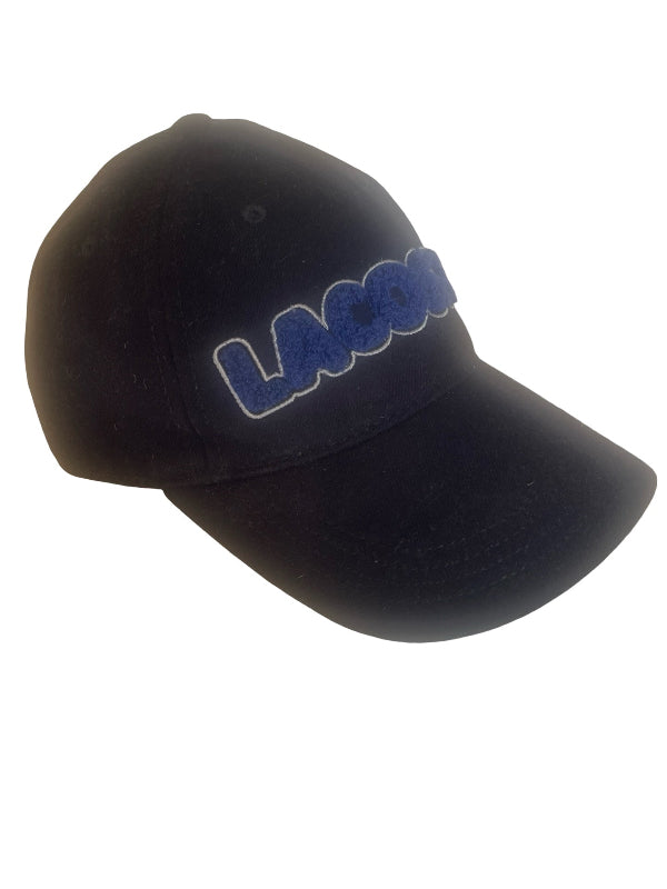 A navy baseball cap featuring the word 'LACOSTE' embroidered in blue with a white outline on the front, set against a plain white background.