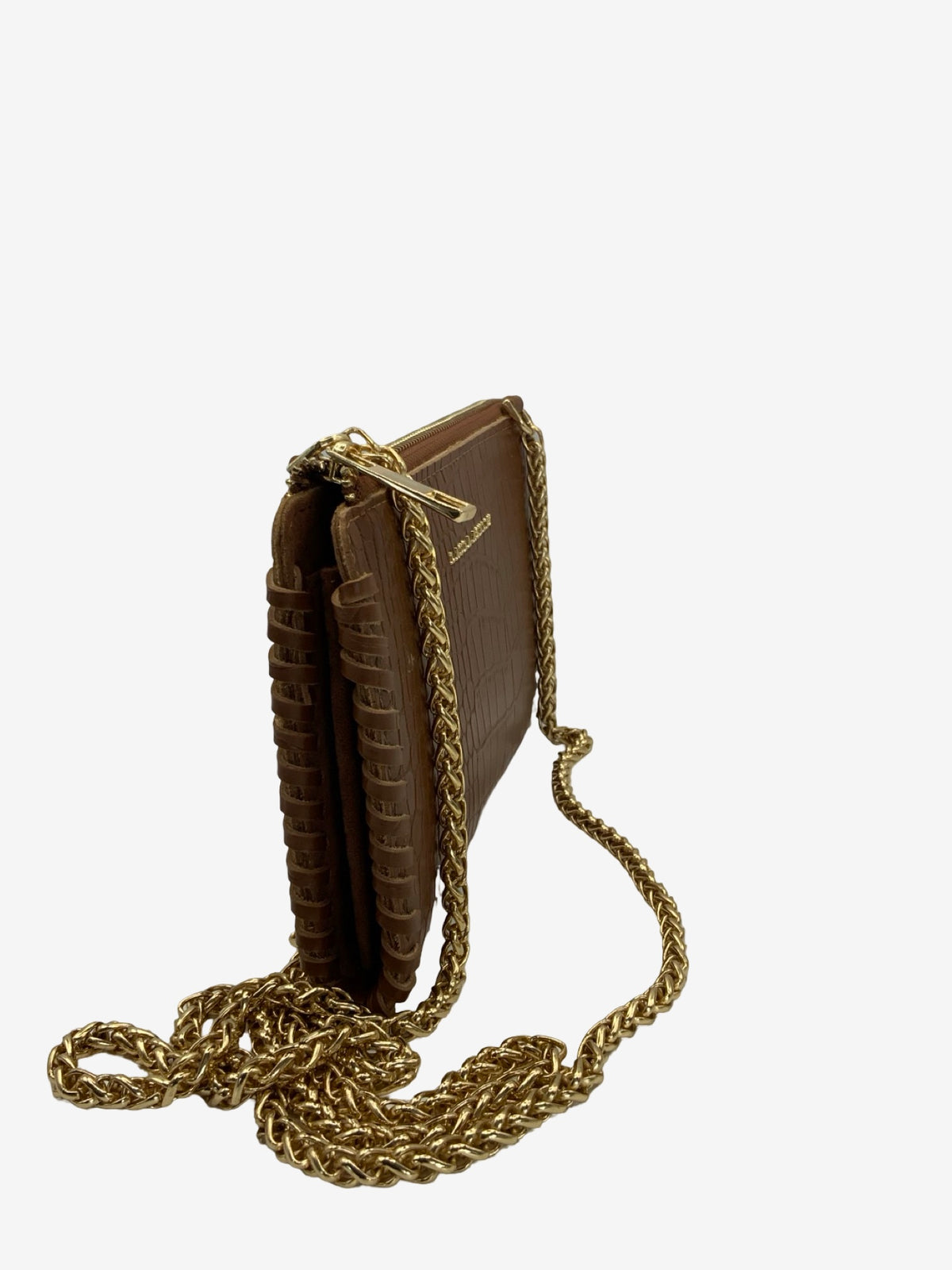 A brown leather crossbody bag designed to look like a vintage hardcover book, featuring textured side panels and a prominent gold-tone chain strap, shown on a plain light gray background.