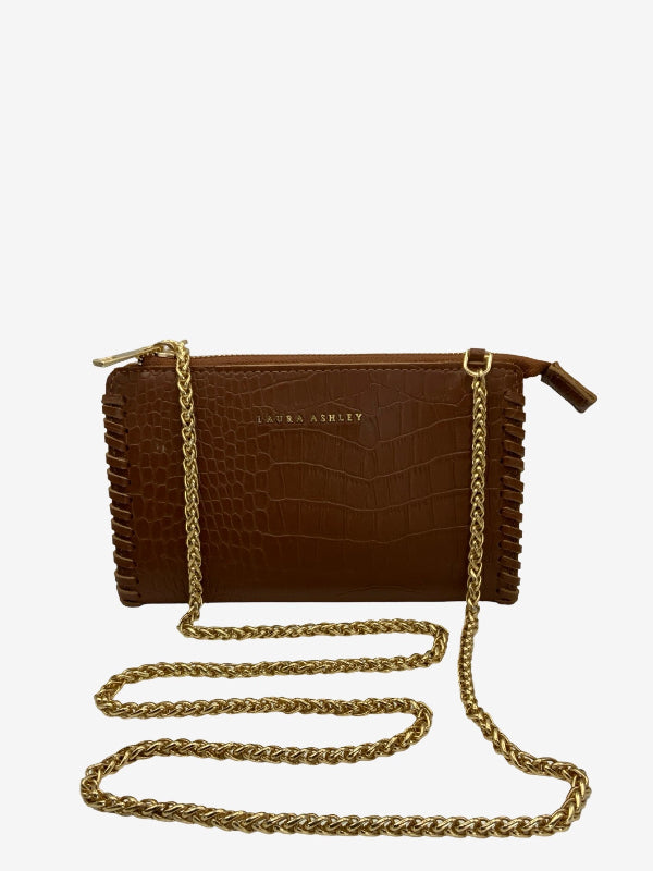 A brown crocodile-embossed leather clutch bag with gold-tone chain strap and zipper pulls, displayed on a clean white background.