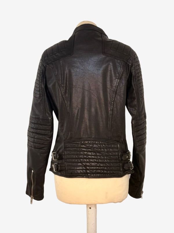 A black  leather motorcycle jacket with quilted shoulder and waist details, displayed on a cream-colored mannequin torso against a white background.