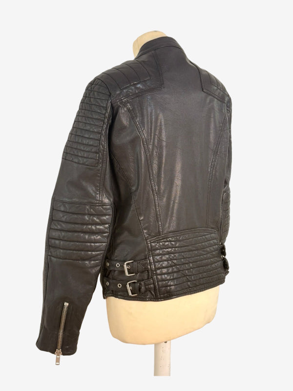 A black leather motorcycle jacket with quilted shoulder and waist panels, displayed on a beige mannequin torso against a light gray background.