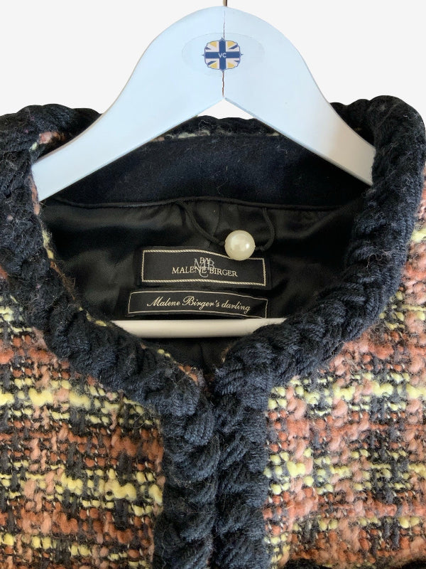 A close-up of a Malene Berger tweed jacket on a white hanger, showing the black corduroy collar, textured multicolor tweed body, and interior labels.
