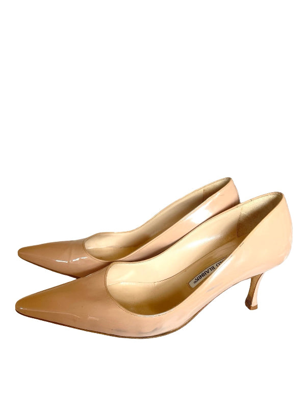 A pair of pointed-toe kitten heel pumps in a glossy nude patent leather, shown from a side profile view against a plain white background.