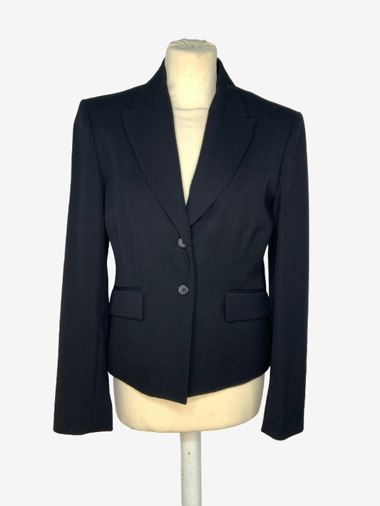 A black tailored blazer jacket displayed on a cream-colored mannequin torso against a light gray background.