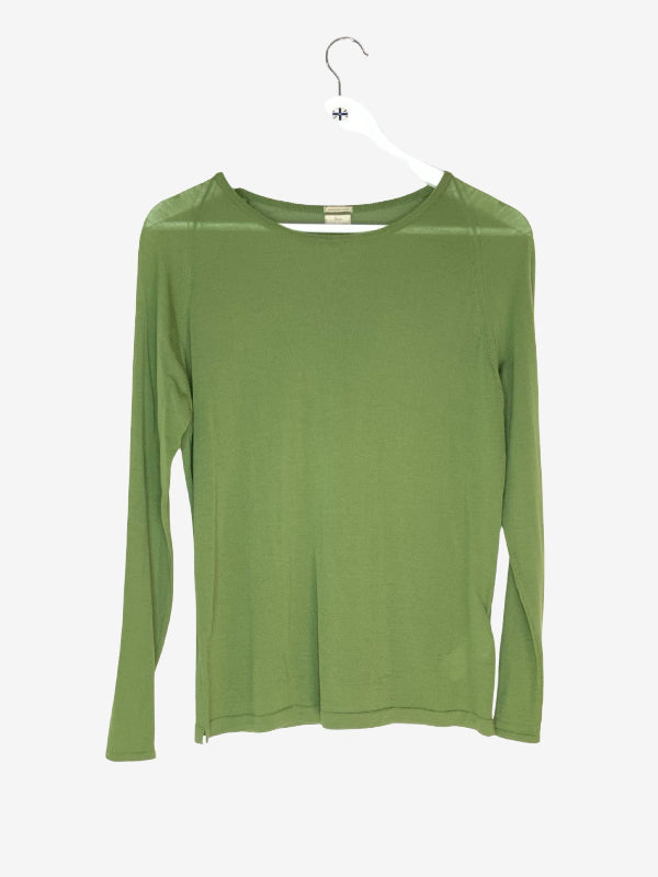 An olive green long-sleeve knit top hanging on a white wooden  hanger against a light gray background.