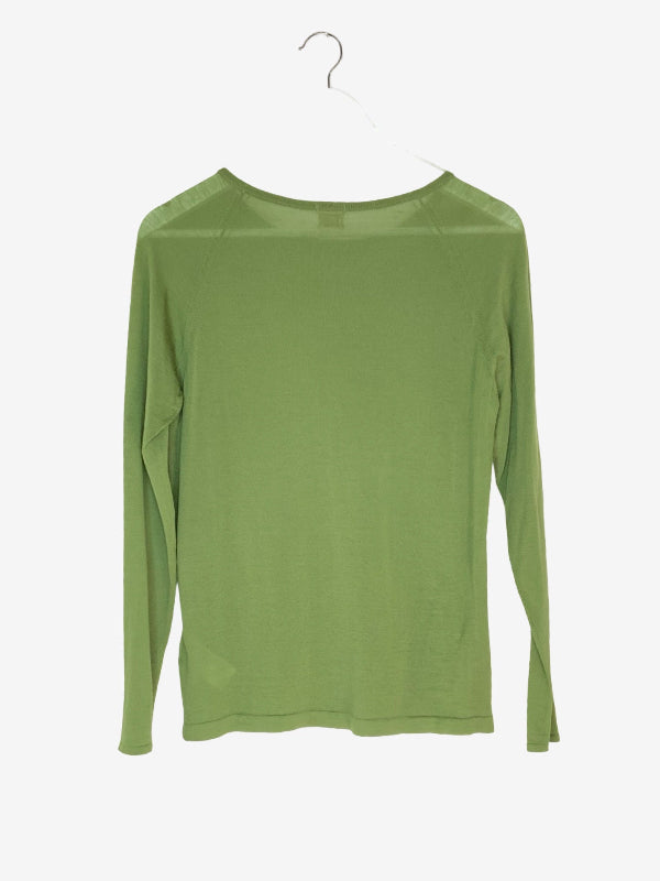 A light olive green long-sleeve top hanging on a white wooden hanger against a plain white background.