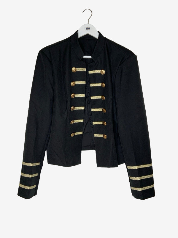 A black military-style jacket with gold buttons and gold stripes on the cuffs, hanging on a white hanger against a light gray background.