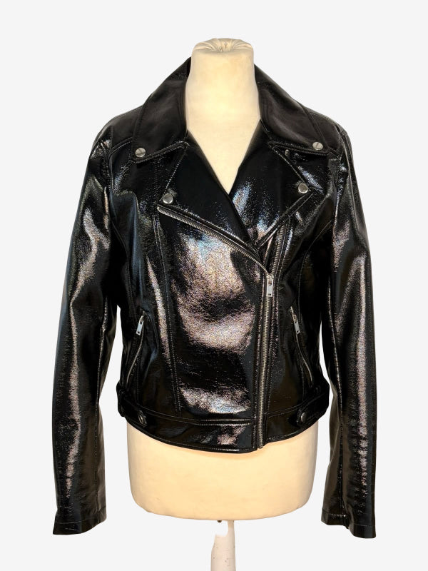 A shiny black faux leather motorcycle jacket with an asymmetrical zipper and silver snap details, displayed on a beige mannequin torso against a light gray background.