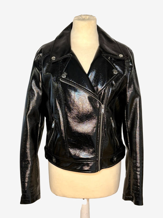A shiny black faux leather motorcycle jacket with an asymmetrical zipper and silver snap details, displayed on a beige mannequin torso against a light gray background.