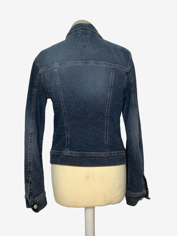A dark blue denim jacket displayed on a cream-colored mannequin torso, showing the back view against a plain white background.