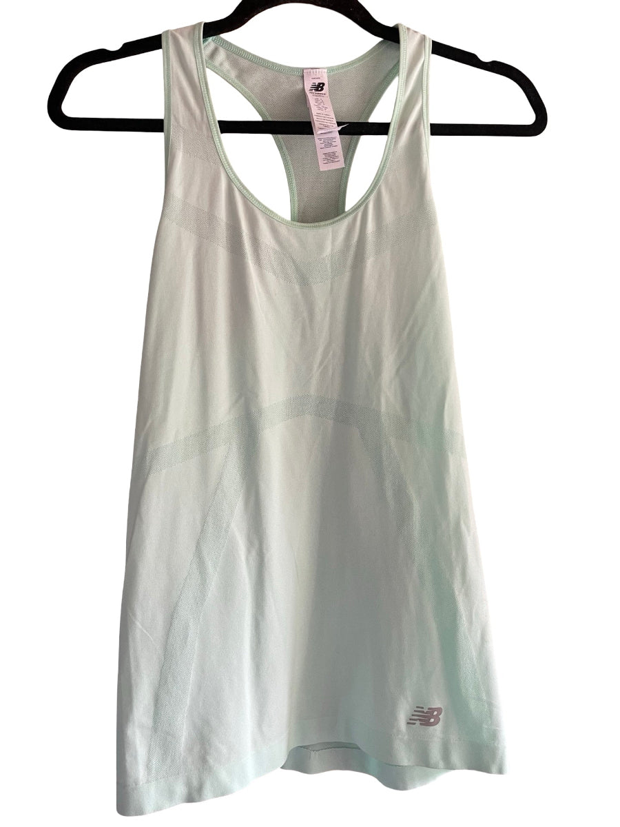 A light sage green New Balance tank top hanging on a black hanger against a white background.
