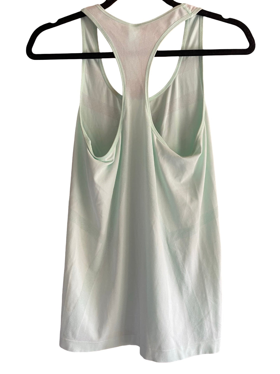 A sleeveless racerback tank top in a very pale mint green color, hanging on a black hanger against a plain white background.