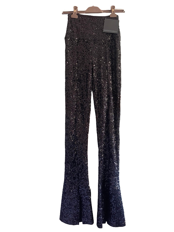 Black sequined flare pants hanging on a wooden hanger against a white background.