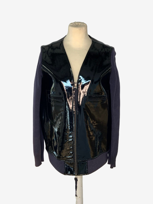 A sleeveless zip-front vest jacket with a glossy black patent leather front and dark purple sleeves, displayed on a mannequin torso against a light gray background.