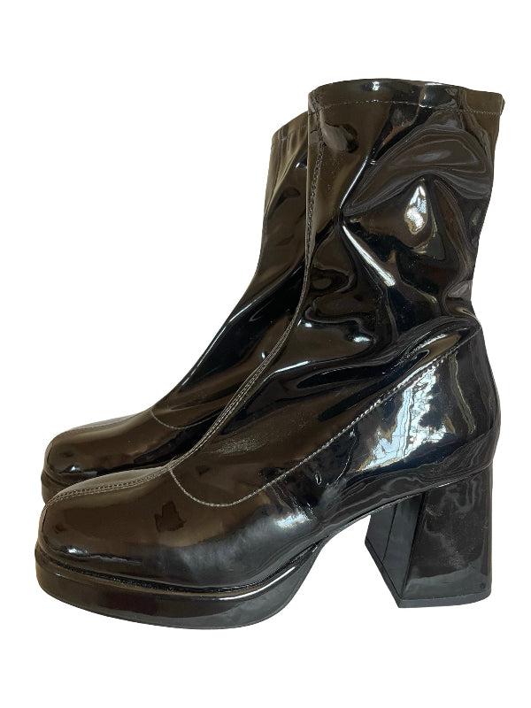 A pair of glossy black patent leather ankle boots with chunky block heels and platform soles, shown against a plain white background.
