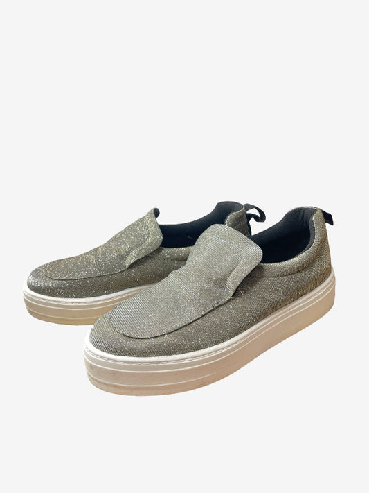 A pair of slip-on platform sneakers in a textured gray suede and glitter finish, featuring a thick beige sole and black lining, shown against a plain light gray background.