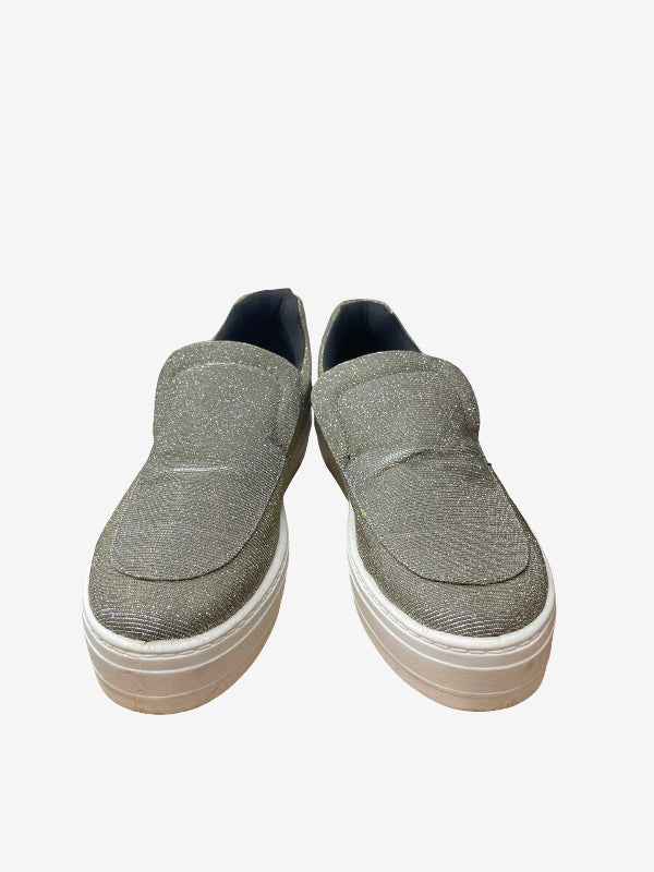 A pair of women's slip-on platform sneakers in a textured gray fabric, featuring a thick white sole and a dark navy blue interior lining, shown against a plain light gray background.