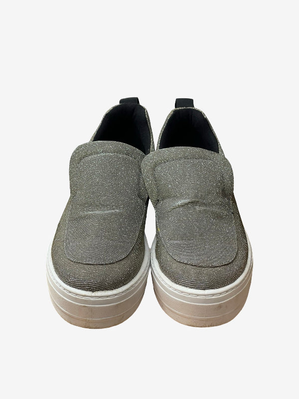 A pair of women's slip-on platform sneakers in a textured gray fabric, featuring a thick white stacked platform sole and black interior lining.