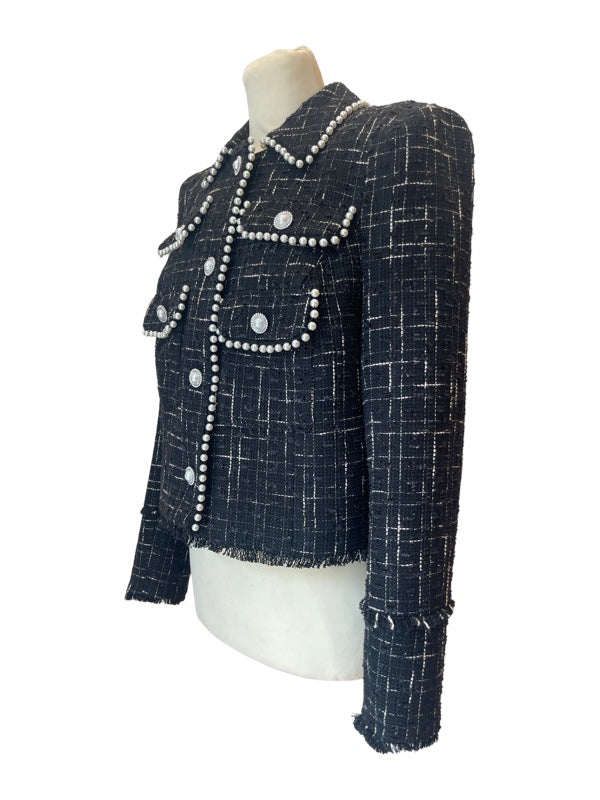 Side view of cropped tweed box jacket black and white with pearl buttons 