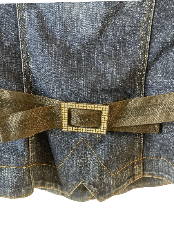 A close-up of a dark brown woven belt with a rhinestone-embellished rectangular buckle, tied around a blue denim garment against a white background.