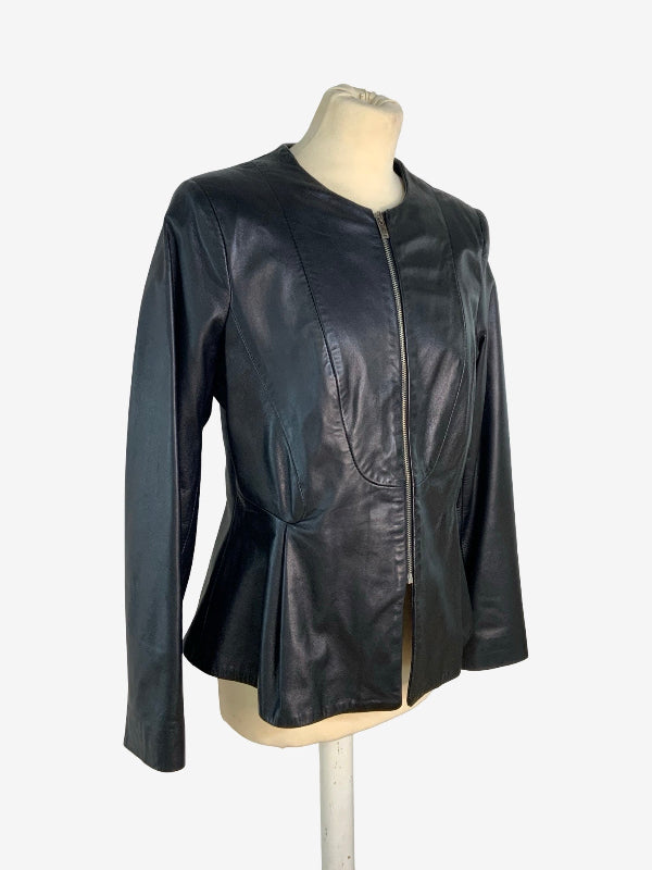 A black leather jacket with a front zipper, displayed on a cream-colored mannequin torso against a plain white background.