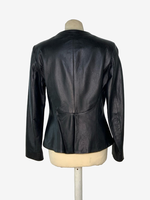 A black leather jacket shown from the back on a cream-colored dress form mannequin, set against a plain white background.
