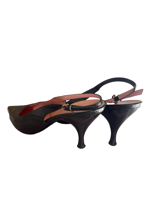 A pair of black slingback kitten heel pumps with a thin brown leather ankle strap and a red interior lining, shown against a plain white background.