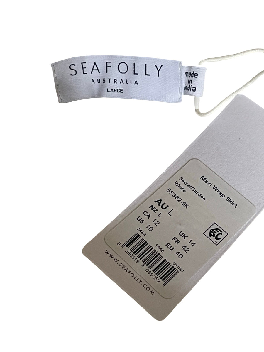 A SeaFolly Australia brand hangtag for a white maxi wrap skirt, showing the brand name, size (Large), and product details alongside a barcode.