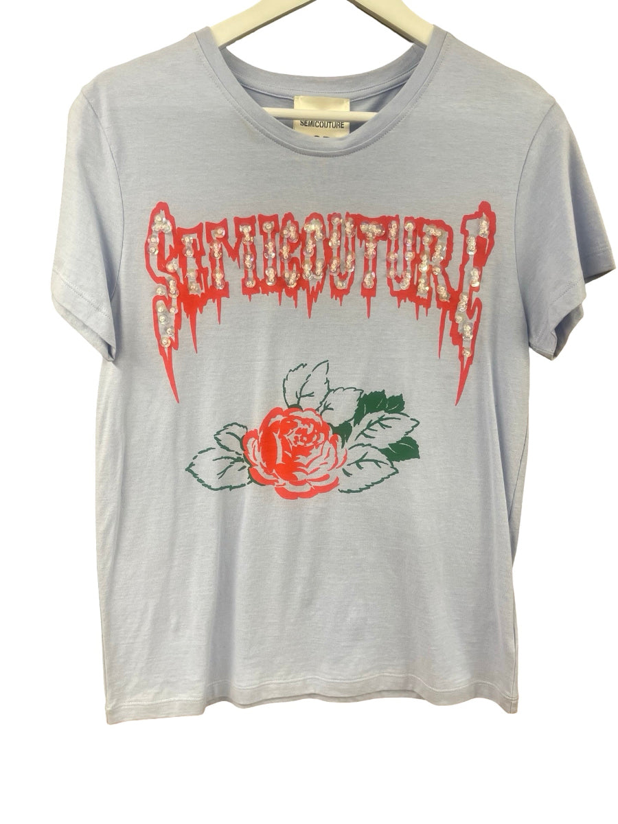 A light gray heathered t-shirt hanging on a wooden hanger, featuring a distressed red 'Semicouture' logo and a red rose graphic on the front.