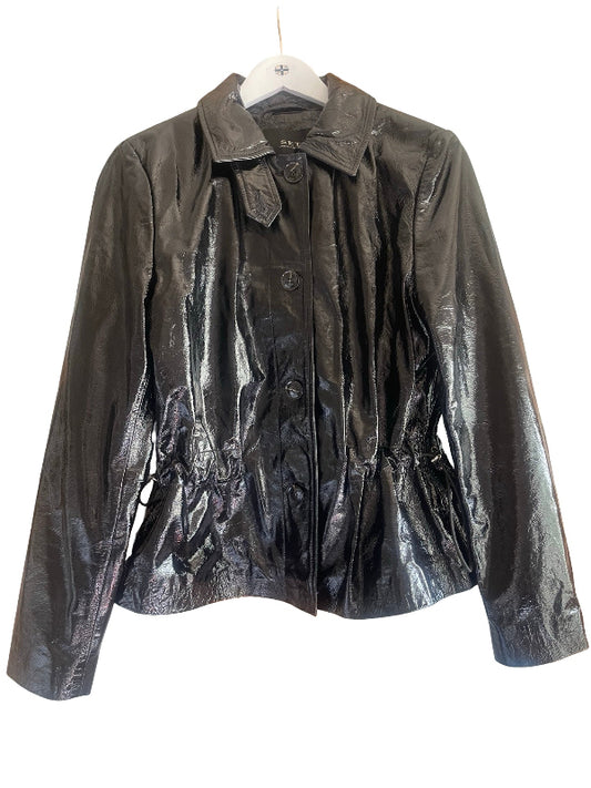 A shiny black leather jacket with a pointed collar, button front, and gathered peplum waist, hanging on a white hanger against a white background.