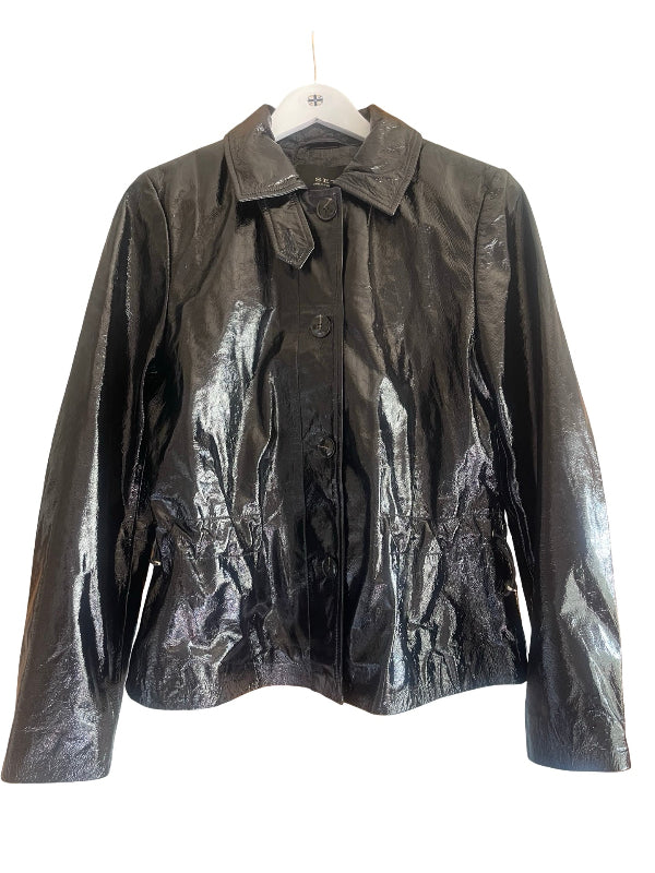 A shiny black leather jacket with a pointed collar and button front, hanging on a white hanger against a plain white background.